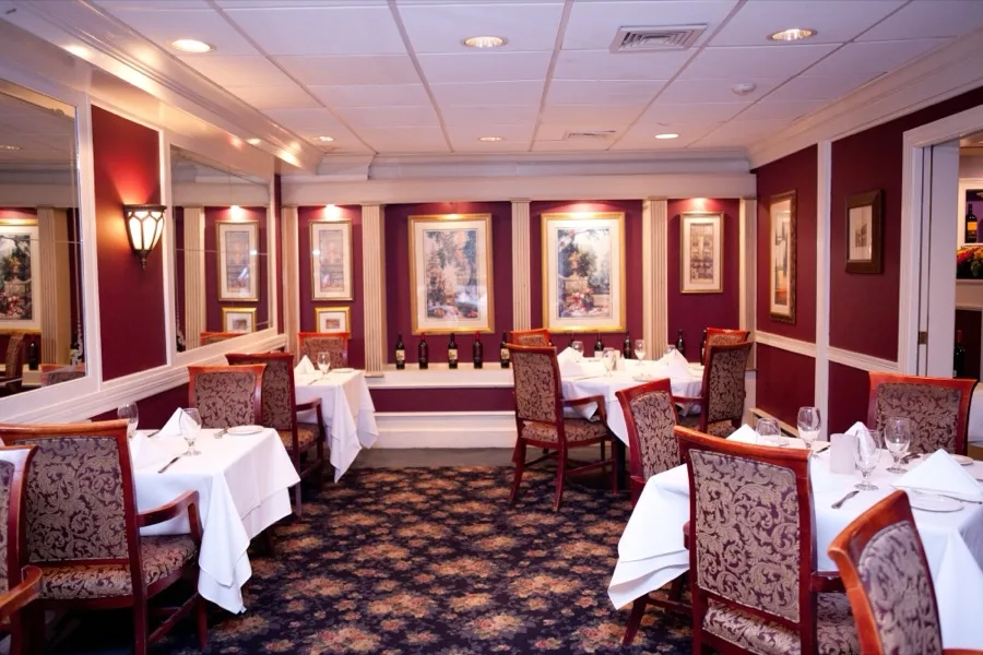 Burgundy dining room with fine art at Luciano's